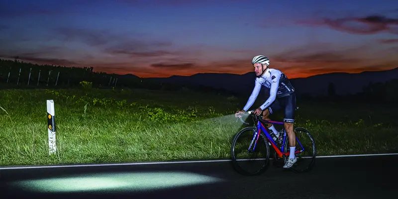 Bike lights for night riding illuminating an unlit road